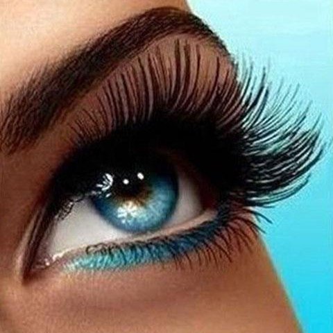 Magnetic lashes worn over teal liner on a blue eye